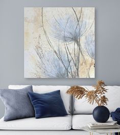 a living room scene with focus on the couch and wall art hanging over the sofa