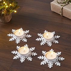 snowflake tealight candles on a wooden table