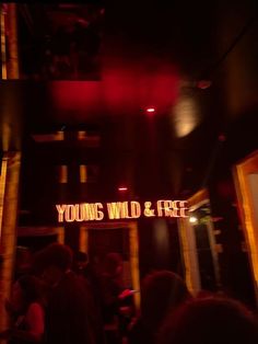 the youngs wild and free sign is lit up at night