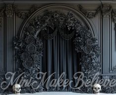 two skulls are sitting in front of a gothic - styled backdrop with roses and leaves