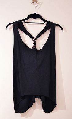 a black top hanging on a white wall