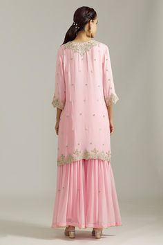 Pink kurta with silver floral embroidered motifs highlighted by cutdana and scalloped borders. Comes with sharara and dupatta.
Components: 3
Pattern: Embroidered
Type Of Work: Sequin,Cutdana
Neckline: Notched
Sleeve Type: Three quarter
Fabric: Georgette,Net
Color: Pink
Other Details: 
Cut-out borders
Gota detail
Attached lining
Closure: Sharara: Elasticated waistband
Occasion: Mehendi and Haldi,Sangeet - Aza Fashions Kurta Sharara Set, Pink Kurta, Kurta Sharara, Embroidered Motifs, Women Kurta, Types Of Work, Straight Kurta, Sharara Set, Pink Sequin