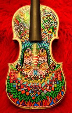 an intricately painted violin on red fur