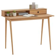 a wooden desk with a drawer on top and a book next to it, in front of a white background