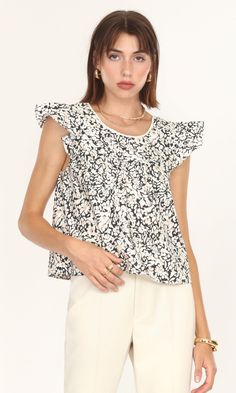 Ruffled sleeves, a thin lace along the neckline, and a squared open-back. This top ties all of that together with a lovely flower print to create a fun, relaxed spring blouse. The fit feels like a loose tank top because the ruffled sleeves extend from the shoulders instead of resting on them. The material is made up of lighter cotton fabric, letting the heat run away. Ruffle poplin top Floral print Ruffled sleeves Square neckline Cotton Self-tie back Crochet scalloped trim Imported Self: 100% Co Spring Blouse, Loose Tank Top, Spring Blouses, Loose Tank, A Beautiful Flower, Loose Tank Tops, Poplin Top, Ruffled Top, Luxury Women Fashion