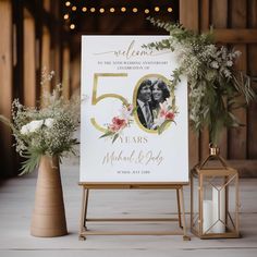 a wedding sign and vases with flowers