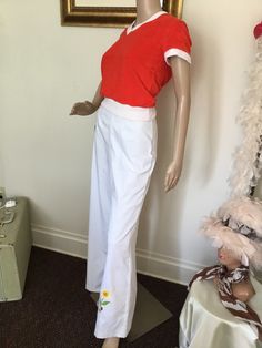 "70's Vintage White High Waist Bell Bottom Pants 70's Vintage White High Waist Bell Bottom Pants White pants with red embroidered lady bug, yellow pink embroidered flowers at bottom of pant legs, Hi rise waist with front/back darts, wide leg bell bottoms, and back button/zip closure. Listing for pants only. Good vintage condition. Has small stains at bottom of pant leg, and two at waist, (see pics). Tag Size: 11 Measurements: Waist: 26\" Rise: 13\" Hips: 36\" Inseam: 31 1/2\" Length: 43 1/2\" Leg Width: 12 1/2 seam to seam" Fitted Wide Leg Cotton Pants For Summer, Vintage Cotton Pants For Spring, Vintage Cotton Spring Pants, Vintage Stretch Cotton Bottoms, Retro Cotton Bottoms For Spring, Retro Fitted Wide Leg Summer Pants, Vintage Stretch Wide Leg Pants, Vintage Full Length Bottoms For Spring, Retro Wide Leg Full Length Pants For Spring