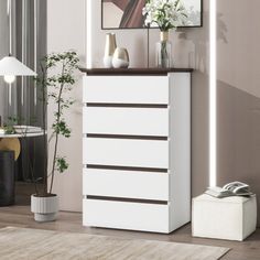 a white chest of drawers in a living room