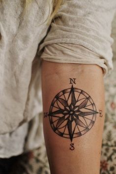 a person with a compass tattoo on their leg