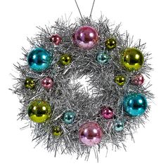 a christmas wreath with ornaments hanging from the front and side of it, on a white background