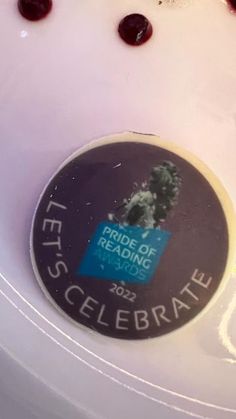 there is a sticker on the side of a toilet bowl that says, pride of reading 2012 celebrate