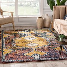 a living room with a large rug on the floor and a chair next to it