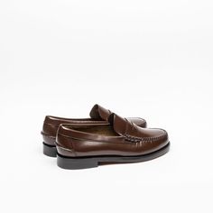 Unlined leatherBrown leatherLeather soleReference: 7000300-901 Dark Brown Dark Brown Color, Penny Loafer, Penny Loafers, Luxury Retail, Luxury Boutique, Loafer Shoes, Brown Color, Boat Shoes, Classic Design