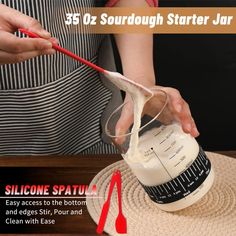 someone pouring cream into a cup on top of a mat with the words, 35oz sourdough starter jar