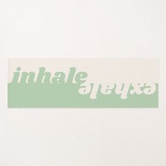 a white and green sticker with the word inhale on it's side