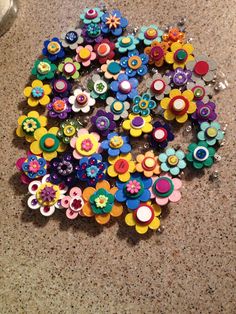 a pile of colorful buttons sitting on top of a counter