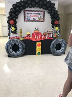 a birthday party with balloons and decorations on the floor, including a monster truck table