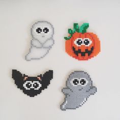 four halloween decorations are shown on a white surface, one has a ghost, the other is a pumpkin