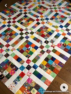 a colorful quilt is laying on the floor