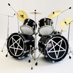 a black and white photo of a set of drums with pentagrams on it