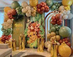 the lion king balloon arch is set up for a birthday party with balloons and decorations