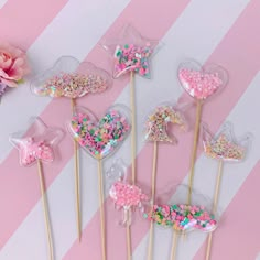 pink and white striped table with candy lollipops