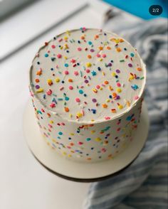 a white cake with sprinkles on it