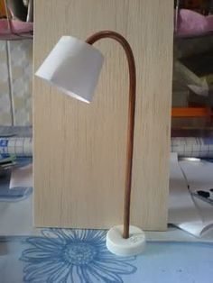 a lamp that is sitting on top of a table next to a wooden block with a flower design