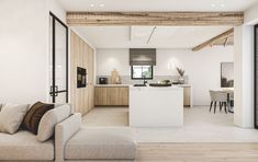 an open concept kitchen and living room with wood beams on the ceiling, white walls and flooring