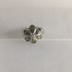 Silver Tone Flower Ring, Size 5.5 With Small Clear/White Stone, Surrounded By Larger Green (Peridot Color) Stones. This Ring Has Never Been Worn. Please, Be Certain To Look At All The Photos Carefully And Definitely Ask Me About Any Questions You May Have Prior To Making A Purchase. Green Flower Ring For Anniversary, Green Emerald Flower Ring For Anniversary, Green Sterling Silver Flower Ring, Peridot Color, Silver Flower Ring, Color Stones, Green Stones, Clear White, Green Peridot