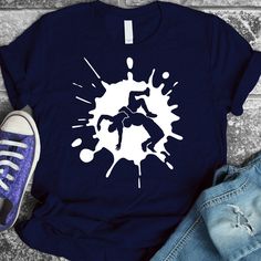 a t - shirt with the image of a person kicking paint on it's chest