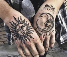 two hands with sun and moon tattoos on them