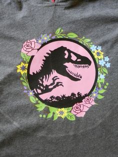 a t - shirt with a dinosaur and flowers on it