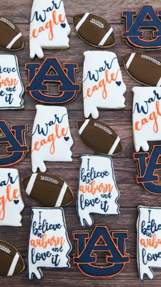 decorated cookies are arranged in the shape of american footballs and words that spell out their name