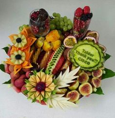 an arrangement of fruits and vegetables are arranged in a bowl