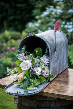 a bouquet of flowers is placed in an old mailbox