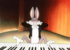 an animated rabbit sitting on top of a piano