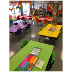 a classroom filled with lots of colorful tables and chairs