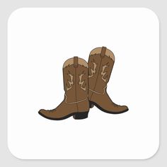 a pair of brown cowboy boots sitting on top of a white square sticker,