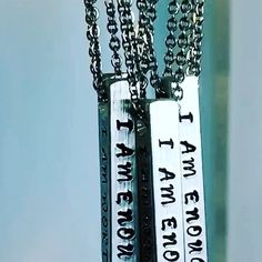 two necklaces that say i am the one who knocks them all by hanging on a chain