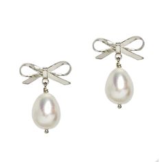 Romantic and sweet, our Olivia Pearl Bow Earrings are hand created with a perfect pair of pearl drops. Handcrafted in NYC High quality white Freshwater Cultured Pearls Electroplated brass 5/8" | 16mm wide x 7/8" long | 22mm long Nickel free Comes in a signature pouch with box Remove pearl jewelry when bathing, showering or swimming. Avoid direct contact with perfume, lotions or other chemicals. Wipe clean with a soft cloth only. Ring Guide, Pearl Bow, Bow Earrings, Freshwater Cultured Pearls, Pearl Drop, Cultured Pearls, Ring Bracelet, Earring Necklace, Pearl Jewelry