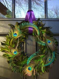 a wreath with peacock feathers and purple ribbon hanging on the front door, along with three pictures of it