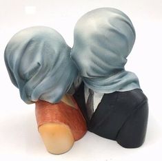 two figurines wearing blue hats and black suits