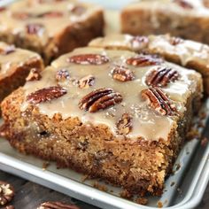 several pieces of cake on a tray with pecans