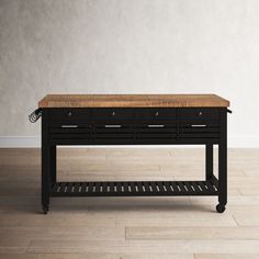 a black and wood table with drawers on it