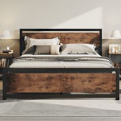 a bed with wooden headboard and foot board sitting in a room next to two nightstands