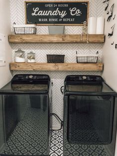 a washer and dryer in a laundry room with shelves above the washers