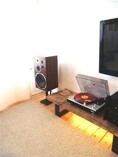 an entertainment center with turntable, stereo and speakers