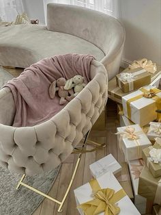 a teddy bear in a baby bed surrounded by presents