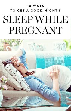 a pregnant woman laying on top of a couch next to a coffee table with flowers